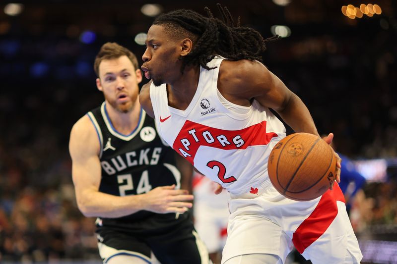 MILWAUKEE, WISCONSIN - NOVEMBER 12: Jonathan Mogbo #2 of the Toronto Raptors drives to the basket against Pat Connaughton #24 of the Milwaukee Bucks during the first half of a game in the NBA Emirates Cup at Fiserv Forum on November 12, 2024 in Milwaukee, Wisconsin. NOTE TO USER: User expressly acknowledges and agrees that, by downloading and or using this photograph, User is consenting to the terms and conditions of the Getty Images License Agreement. (Photo by Stacy Revere/Getty Images)