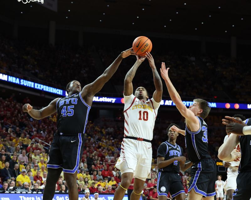 Mar 6, 2024; Ames, Iowa, USA; Brigham Young Cougars forward Fousseyni Traore (45) blocks the shot from Iowa State Cyclones guard Keshon Gilbert (10) at James H. Hilton Coliseum. Mandatory Credit: Reese Strickland-USA TODAY Sports

