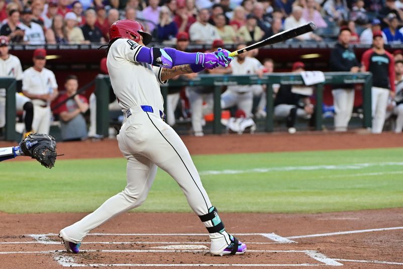 May 1, 2024; Phoenix, Arizona, USA;  Arizona Diamondbacks second base Ketel Marte (4) hits a double in the first inning against the Los Angeles Dodgers at Chase Field. Mandatory Credit: Matt Kartozian-USA TODAY Sports