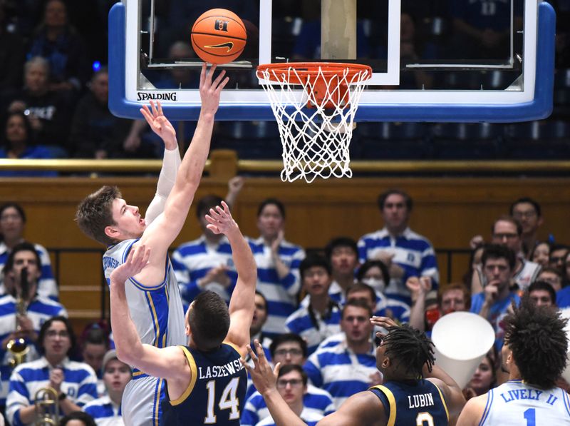 Feb 14, 2023; Durham, North Carolina, USA;  Duke Blue Devils center Kyle Filipowski(30) shoots over Notre Dame Fighting Irish forward Nate Laszewski (14) during the first half at Cameron Indoor Stadium. Mandatory Credit: Rob Kinnan-USA TODAY Sports