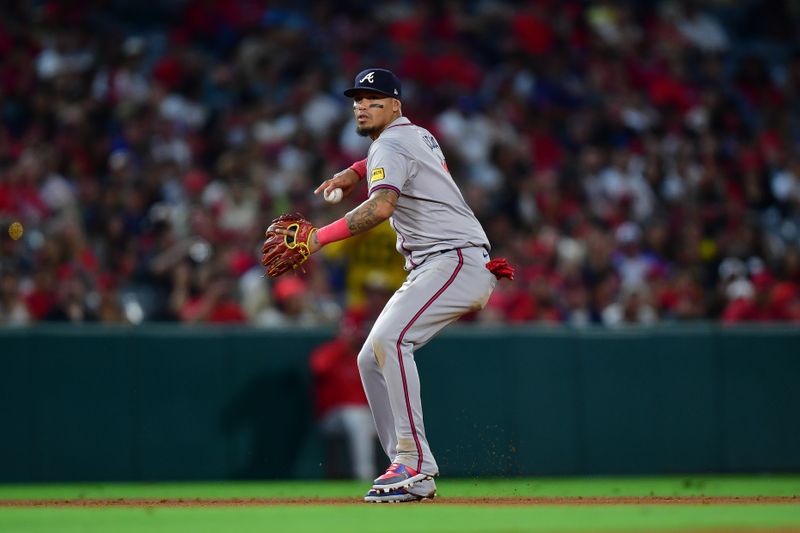 August 16, 2024; Anaheim, California, USA; Atlanta Braves shortstop Orlando Arcia (11) throws to first for the out against Los Angeles Angels second base Brandon Drury (23) during the eighth inning at Angel Stadium. Mandatory Credit: Gary A. Vasquez-USA TODAY Sports