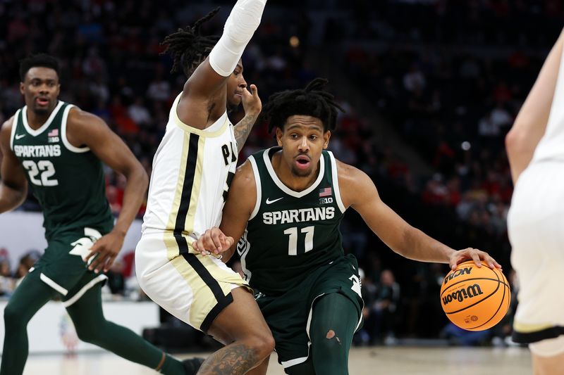 Mar 15, 2024; Minneapolis, MN, USA; Michigan State Spartans guard A.J. Hoggard (11) works around Purdue Boilermakers guard Lance Jones (55) during the second half at Target Center. Mandatory Credit: Matt Krohn-USA TODAY Sports