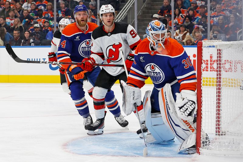 Nov 4, 2024; Edmonton, Alberta, CAN; New Jersey Devils forward Dawson Mercer (91) and Edmonton Oilers goaltender Calvin Pickard (30) looks for a loose puck during the second period at Rogers Place. Mandatory Credit: Perry Nelson-Imagn Images