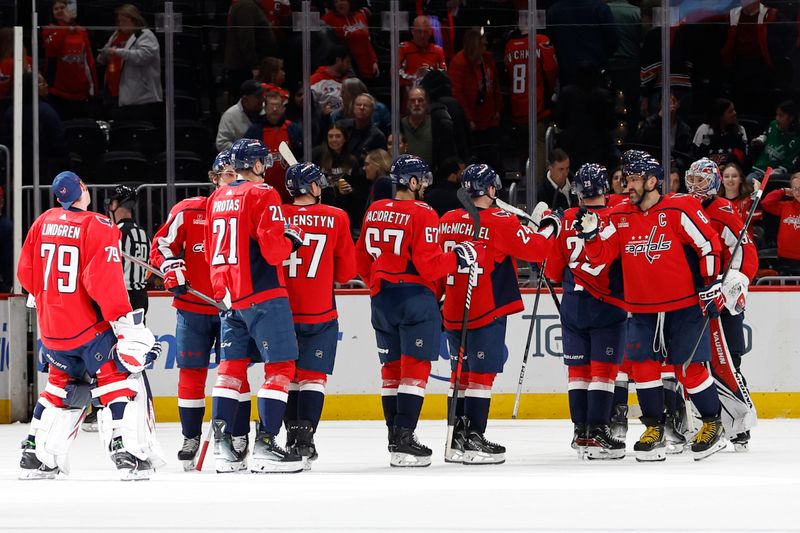 Feb 26, 2024; Washington, District of Columbia, USA; Washington Capitals players celebrate after their game against the Ottawa Senators at Capital One Arena. Mandatory Credit: Geoff Burke-USA TODAY Sports