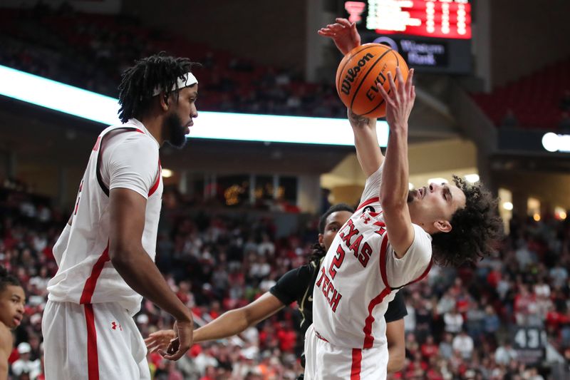 Feb 10, 2024; Lubbock, Texas, USA;  Texas Tech Red Raiders guard Pop Isaacs (2) reaches for a rebound against Central Florida Knights guard Shemarri Allen (2) in the first half United Supermarkets Arena. Mandatory Credit: Michael C. Johnson-USA TODAY Sports