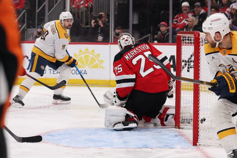 Jan 29, 2026; Newark, New Jersey, USA; Nashville Predators left wing Filip Forsberg (9) scores a goal on New Jersey Devils goaltender Jacob Markstrom (25) during the third period at Prudential Center. Mandatory Credit: Ed Mulholland-Imagn Images