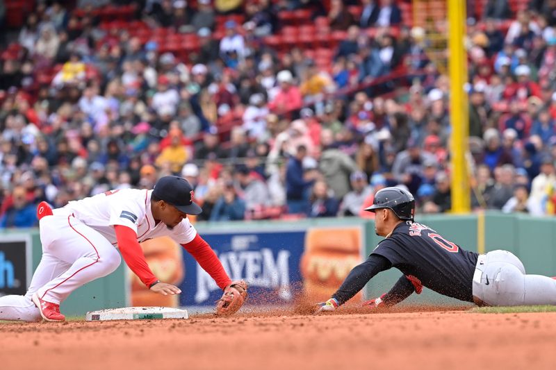 Apr 18, 2024; Boston, Massachusetts, USA; Boston Red Sox second baseman Enmanuel Valdez (47)  beats Cleveland Guardians second baseman Andres Gimenez (0) to the basde during the third inning at Fenway Park. Mandatory Credit: Eric Canha-USA TODAY Sports