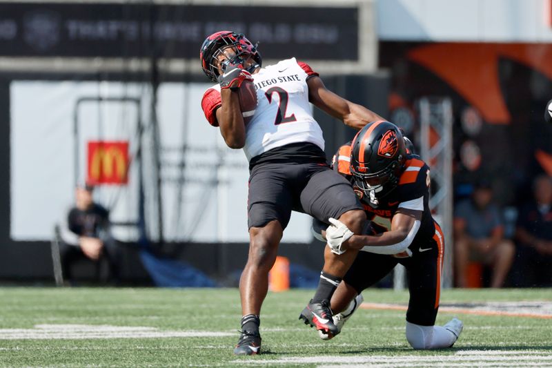 Sep 16, 2023; Corvallis, Oregon, USA; San Diego State Aztecs running back Jaylon Armstead (2) is tackled by Oregon State Beavers defensive back Jaden Robinson (4) during the second half at Reser Stadium. Mandatory Credit: Soobum Im-USA TODAY Sports