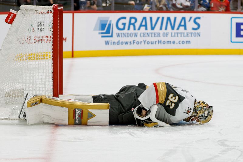 Nov 27, 2024; Denver, Colorado, USA; Vegas Golden Knights goaltender Adin Hill (33) lies not the ice after a play in the second period against the Colorado Avalanche at Ball Arena. Mandatory Credit: Isaiah J. Downing-Imagn Images