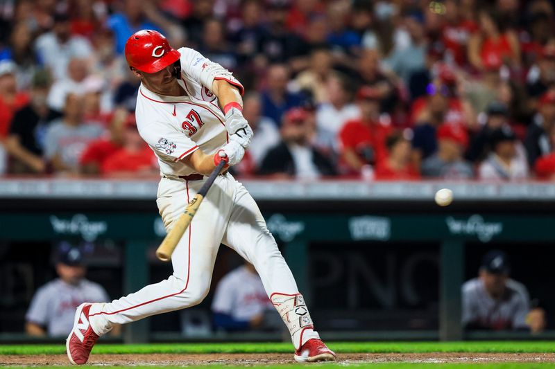 Sep 17, 2024; Cincinnati, Ohio, USA; Cincinnati Reds catcher Tyler Stephenson (37) hits a single in the seventh inning against the Atlanta Braves at Great American Ball Park. Mandatory Credit: Katie Stratman-Imagn Images