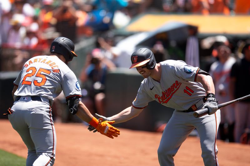 Jul 7, 2024; Oakland, California, USA; Baltimore Orioles right fielder Anthony Santander (25) celebrates his home run against the Oakland Athletics with teammate Jordan Westburg (11) during the first inning at Oakland-Alameda County Coliseum. Mandatory Credit: D. Ross Cameron-USA TODAY Sports
