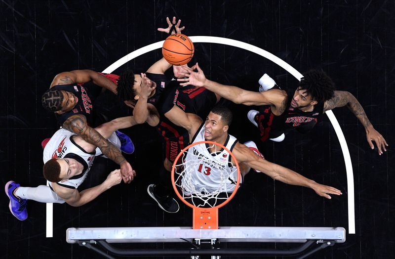 Jan 6, 2024; San Diego, California, USA; San Diego State Aztecs forward Jaedon LeDee (13) battles for a rebound against UNLV Rebels forward Jalen Hill (1) and forward Isaiah Cottrell (0) during the first half at Viejas Arena. Mandatory Credit: Orlando Ramirez-USA TODAY Sports