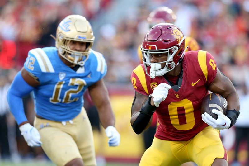 Nov 18, 2023; Los Angeles, California, USA; USC Trojans running back MarShawn Lloyd (0) runs during the second quarter against the UCLA Bruins at United Airlines Field at Los Angeles Memorial Coliseum. Mandatory Credit: Jason Parkhurst-USA TODAY Sports