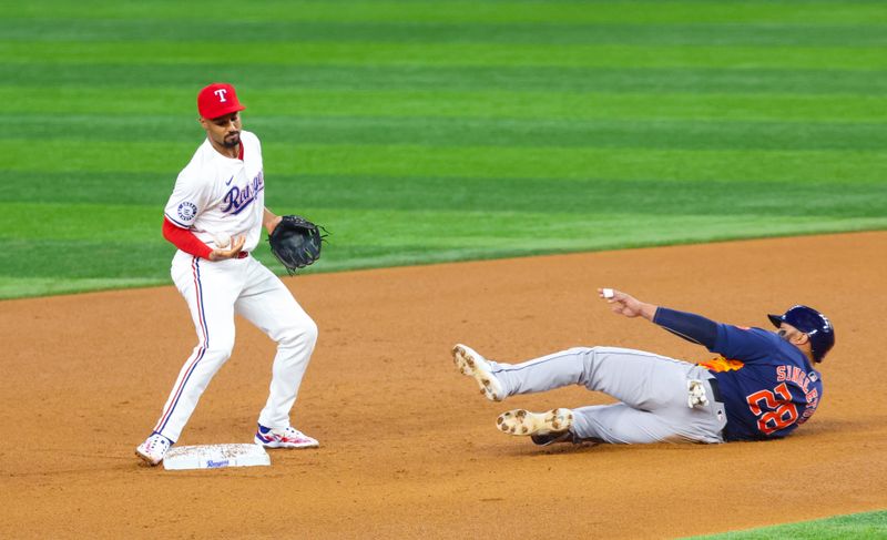 Aug 6, 2024; Arlington, Texas, USA; Texas Rangers second baseman Marcus Semien (2) bobbles the ball as Houston Astros first baseman Jon Singleton (28) slides into second base during the fourth inning at Globe Life Field. Mandatory Credit: Kevin Jairaj-USA TODAY Sports