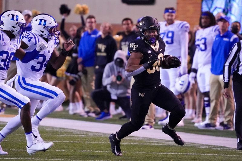 Oct 30, 2021; Winston-Salem, North Carolina, USA;  Wake Forest Demon Deacons running back Ahmani Marshall (30) runs with the ball during the second half against the Duke Blue Devils at Truist Field. Mandatory Credit: James Guillory-USA TODAY Sports