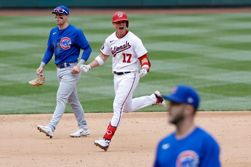 May 4, 2023; Washington, District of Columbia, USA; Washington Nationals left fielder Alex Call (17) celebrates while rounding the bases after hitting a walk-off home run as Chicago Cubs second baseman Nico Hoerner (2) and Cubs relief pitcher Brad Boxberger (R) leave the field at Nationals Park. Mandatory Credit: Geoff Burke-USA TODAY Sports