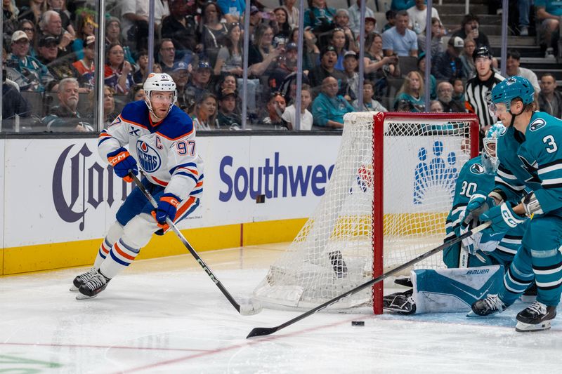 Feb 28, 2026; San Jose, California, USA; Edmonton Oilers center Connor McDavid (97) passes the puck from behind the net against the San Jose Sharks during the first period at SAP Center at San Jose. Mandatory Credit: Neville E. Guard-Imagn Images