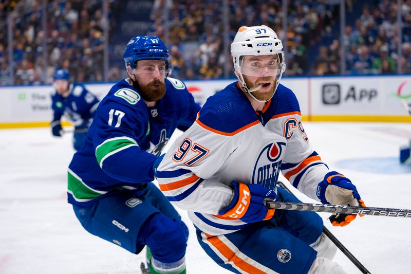 May 8, 2024; Vancouver, British Columbia, CAN; Vancouver Canucks defenseman Filip Hronek (17) battles with Edmonton Oilers forward Connor McDavid (97) during the second period in game one of the second round of the 2024 Stanley Cup Playoffs at Rogers Arena. Mandatory Credit: Bob Frid-USA TODAY Sports