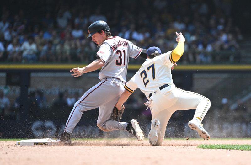 Jun 21, 2023; Milwaukee, Wisconsin, USA; Arizona Diamondbacks right fielder Jake McCarthy (31) slides in safely ahead of the tag by Milwaukee Brewers shortstop Willy Adames (27) in the fifth inning at American Family Field. Mandatory Credit: Michael McLoone-USA TODAY Sports