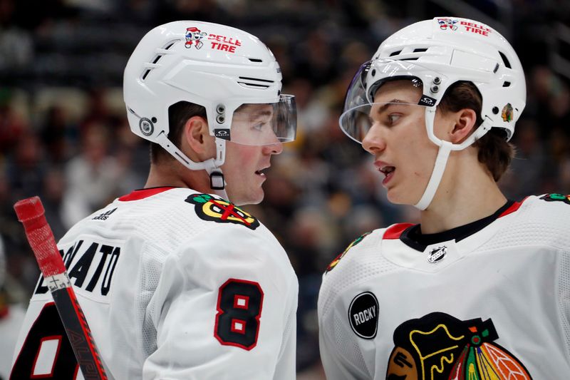 Oct 10, 2023; Pittsburgh, Pennsylvania, USA; Chicago Blackhawks center Ryan Donato (8) and center Connor Bedard (right) talk before a face-off against the Pittsburgh Penguins during the third period at the PPG Paints Arena. Chicago won 4-2. Mandatory Credit: Charles LeClaire-USA TODAY Sports