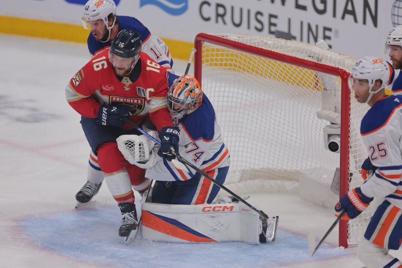 Jun 9, 2025; Sunrise, Florida, USA; Edmonton Oilers goaltender Stuart Skinner (74) defends against Florida Panthers forward Aleksander Barkov (16) during the second period in game three of the 2025 Stanley Cup Final at Amerant Bank Arena. Mandatory Credit: Sam Navarro-Imagn Images