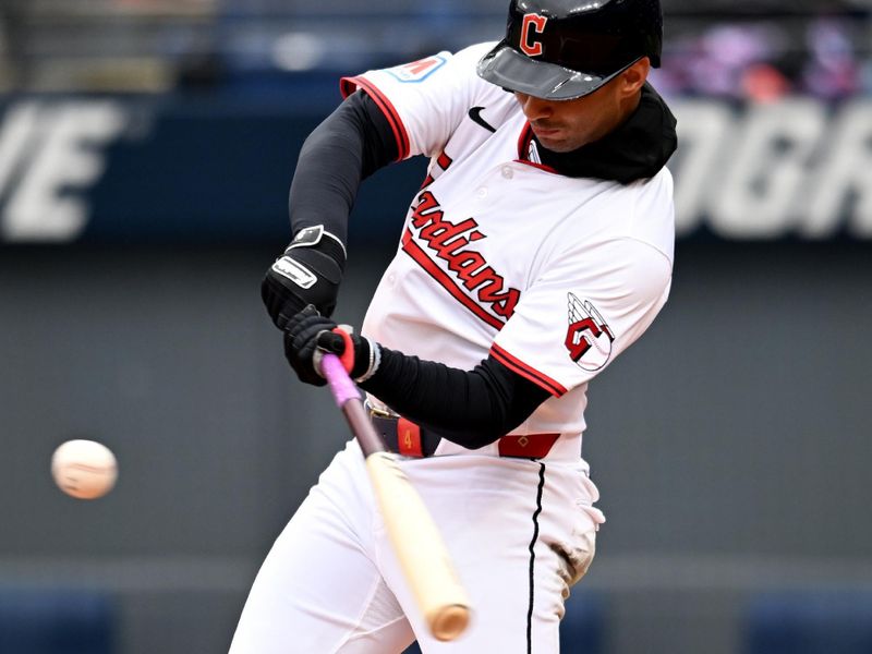 Apr 10, 2025; Cleveland, Ohio, USA; Cleveland Guardians shortstop Brayan Rocchio (4) hits a double during the third inning against the Chicago White Sox at Progressive Field. Mandatory Credit: Ken Blaze-Imagn Images