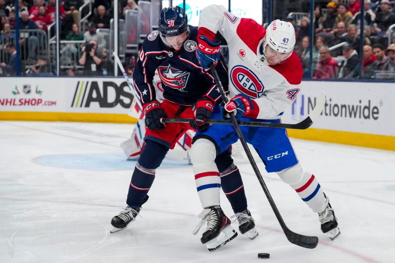 Nov 29, 2023; Columbus, Ohio, USA;  Columbus Blue Jackets left wing Eric Robinson (50) battles for the puck against Montreal Canadiens defenseman Jayden Struble (47) in the second period at Nationwide Arena. Mandatory Credit: Aaron Doster-USA TODAY Sports