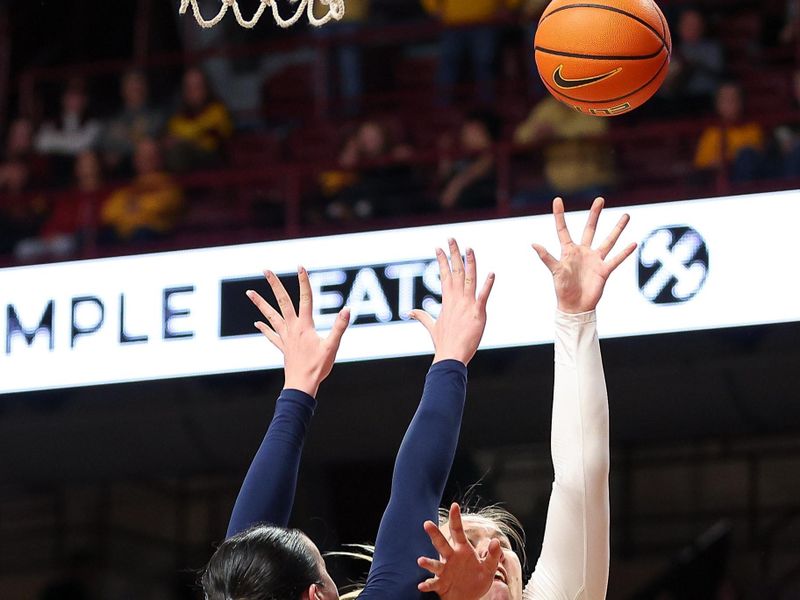 Jan 31, 2024; Minneapolis, Minnesota, USA; Minnesota Golden Gophers center Sophie Hart (52) shoots as Penn State Nittany Lions forward Ali Brigham (1) defends during the first half at Williams Arena. Mandatory Credit: Matt Krohn-USA TODAY Sports