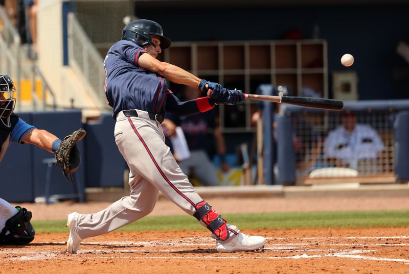 Mar 18, 2024; Port Charlotte, Florida, USA; Atlanta Braves infielder Andrew Velazquez (65) hits a home run during the fifth inning against the Tampa Bay Rays at Charlotte Sports Park. Mandatory Credit: Kim Klement Neitzel-USA TODAY Sports