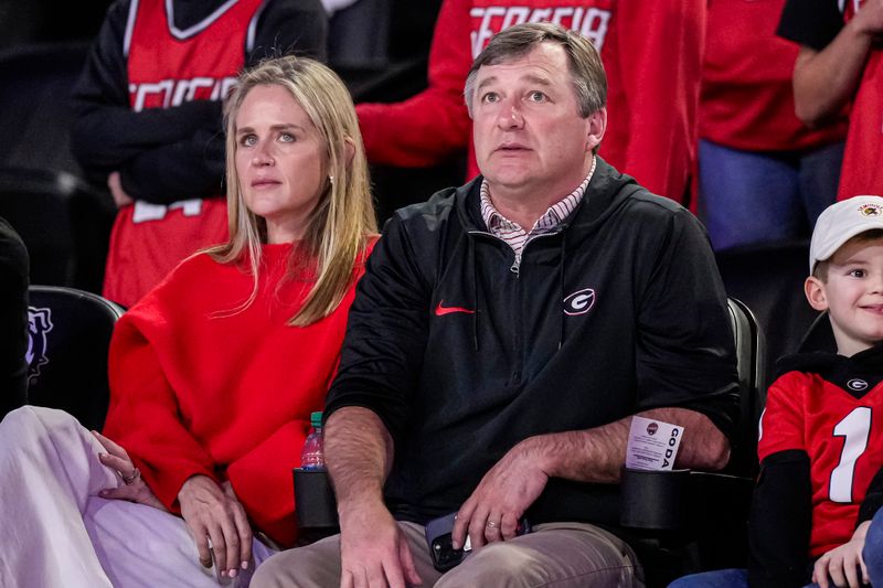 Feb 17, 2024; Athens, Georgia, USA; Georgia Bulldogs head football coach Kirby Smart and his wife Mary Beth Smart watch the basketball game between Georgia and the Florida Gators at Stegeman Coliseum. Mandatory Credit: Dale Zanine-USA TODAY Sports