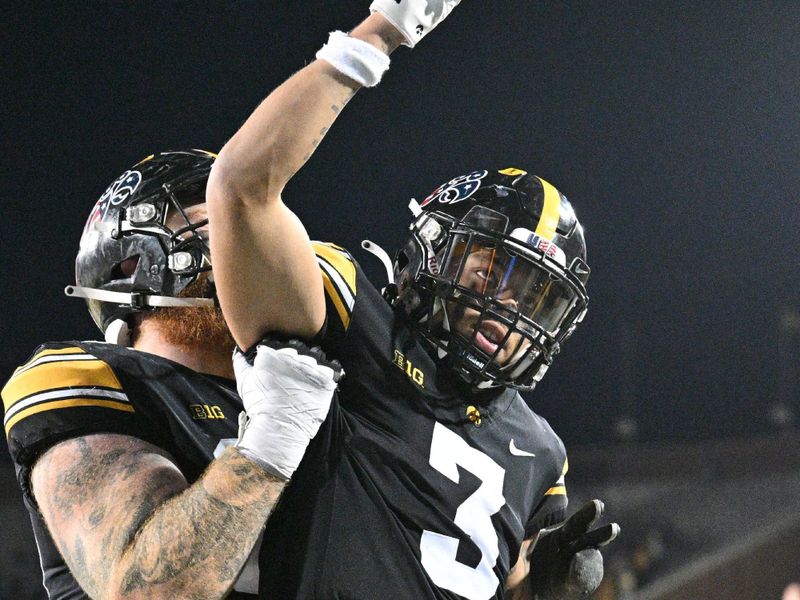 Nov 11, 2023; Iowa City, Iowa, USA; Iowa Hawkeyes wide received Kaleb Brown (3) and offensive lineman Rusty Feth (rear) react during the fourth quarter against the Rutgers Scarlet Knights at Kinnick Stadium. Mandatory Credit: Jeffrey Becker-USA TODAY Sports