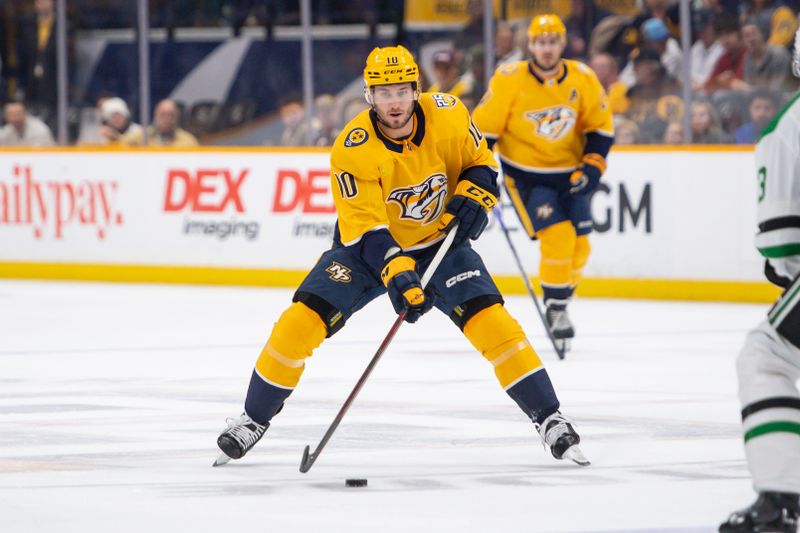 Feb 15, 2024; Nashville, Tennessee, USA; Nashville Predators center Colton Sissons (10) skates with the puck  against the Dallas Stars during the first period at Bridgestone Arena. Mandatory Credit: Steve Roberts-USA TODAY Sports