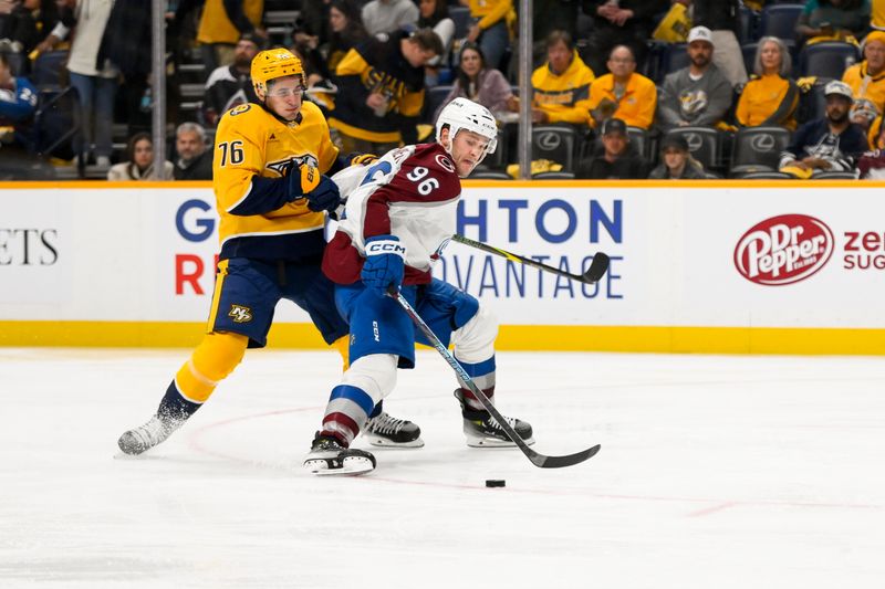 Nov 2, 2024; Nashville, Tennessee, USA;  Nashville Predators defenseman Brady Skjei (76) and Colorado Avalanche right wing Mikko Rantanen (96) fight for the puck during the second period at Bridgestone Arena. Mandatory Credit: Steve Roberts-Imagn Images