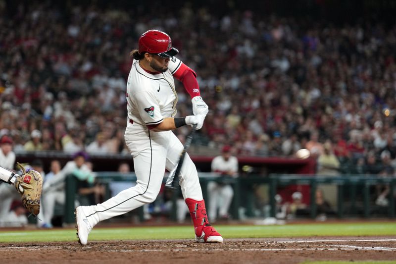 Sep 29, 2024; Phoenix, Arizona, USA; Arizona Diamondbacks second base Ketel Marte (4) hits an RBI single against the San Diego Padres during the fourth inning at Chase Field. Mandatory Credit: Joe Camporeale-Imagn Images