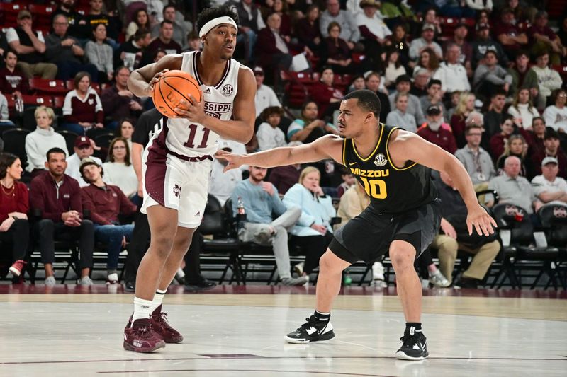 Feb 4, 2023; Starkville, Mississippi, USA; Mississippi State Bulldogs guard Eric Reed Jr. (11) handles the ball while defended by Missouri Tigers guard Nick Honor (10) during the first half at Humphrey Coliseum. Mandatory Credit: Matt Bush-USA TODAY Sports