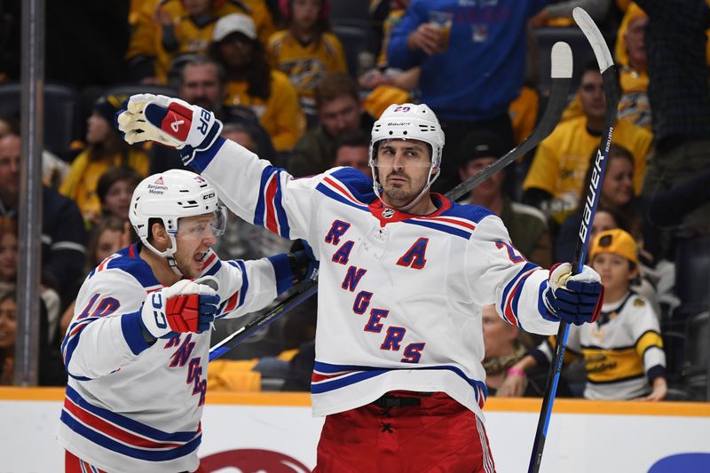 Dec 2, 2023; Nashville, Tennessee, USA; New York Rangers left wing Chris Kreider (20) and left wing Artemi Panarin (10) celebrate after a goal against the Nashville Predators during the second period at Bridgestone Arena. Mandatory Credit: Christopher Hanewinckel-USA TODAY Sports