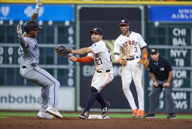 Jul 10, 2024; Houston, Texas, USA; Houston Astros second baseman Jose Altuve (27) attempts to tag Miami Marlins right fielder Dane Myers (54) on a play during the seventh inning at Minute Maid Park. Mandatory Credit: Troy Taormina-USA TODAY Sports