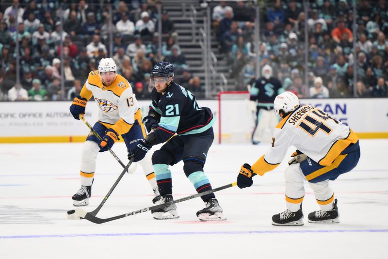 Nov 2, 2023; Seattle, Washington, USA; Seattle Kraken center Alex Wennberg (21) plays the puck while defended by Nashville Predators left wing Kiefer Sherwood (44) during the third period at Climate Pledge Arena. Mandatory Credit: Steven Bisig-USA TODAY Sports