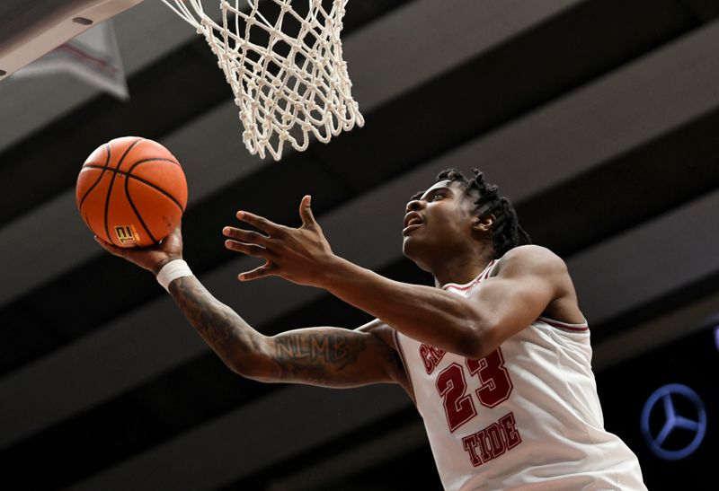 Mar 2, 2024; Tuscaloosa, Alabama, USA;  Alabama forward Nick Pringle (23) scores at the rim during the game with Tennessee at Coleman Coliseum. Mandatory Credit: Gary Cosby Jr.-USA TODAY Sports