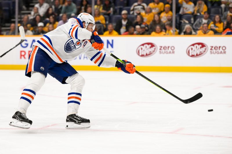 Oct 31, 2024; Nashville, Tennessee, USA;  Edmonton Oilers center Leon Draisaitl (29) shoots and scores past Nashville Predators goaltender Juuse Saros (74) during the second period at Bridgestone Arena. Mandatory Credit: Steve Roberts-Imagn Images