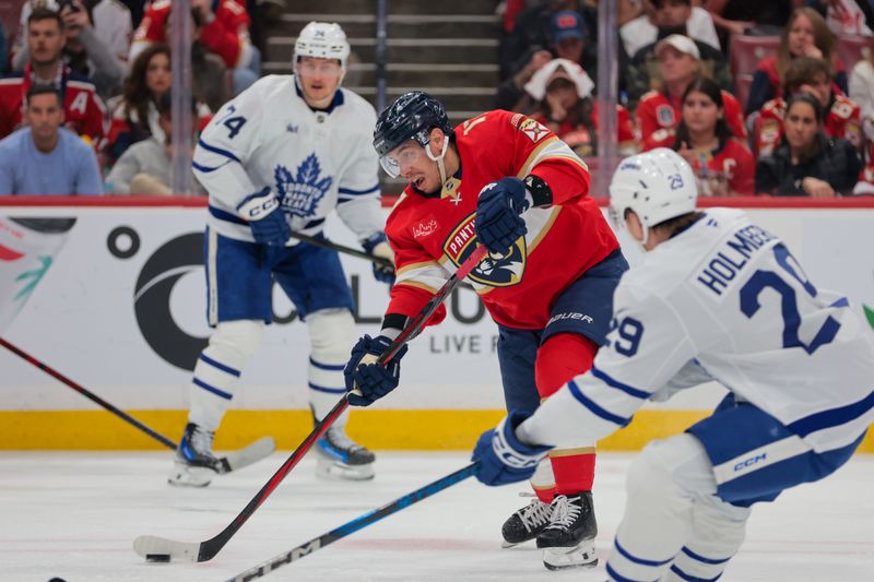 May 9, 2025; Sunrise, Florida, USA; Florida Panthers center Evan Rodrigues (17) shoots the puck against the Toronto Maple Leafs during the second period in game three of the second round of the 2025 Stanley Cup Playoffs at Amerant Bank Arena. Mandatory Credit: Sam Navarro-Imagn Images