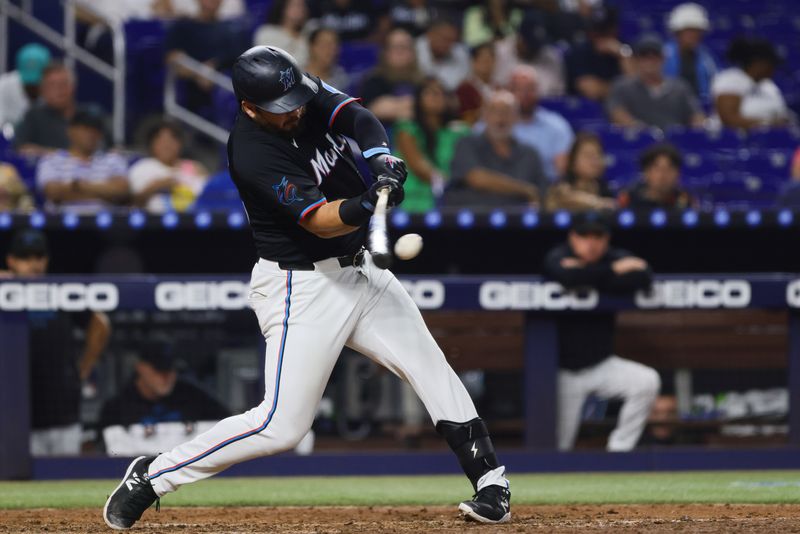 Aug 23, 2024; Miami, Florida, USA; Miami Marlins first baseman Jake Burger (36) hits a single against the Chicago Cubs during the fifth inning at loanDepot Park. Mandatory Credit: Sam Navarro-USA TODAY Sports