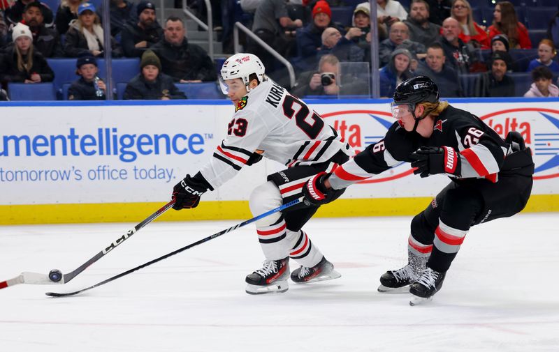 Jan 18, 2024; Buffalo, New York, USA;  Buffalo Sabres defenseman Rasmus Dahlin (26) tries to block a shot by Chicago Blackhawks center Philipp Kurashev (23) during the first period at KeyBank Center. Mandatory Credit: Timothy T. Ludwig-USA TODAY Sports