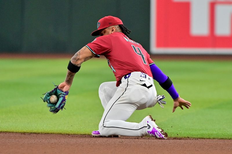 May 15, 2024; Phoenix, Arizona, USA;  Arizona Diamondbacks second baseman Ketel Marte (4) fields a ground ball in the fourth inning against the Cincinnati Reds at Chase Field. Mandatory Credit: Matt Kartozian-USA TODAY Sports