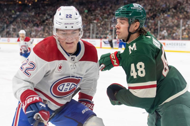 Dec 21, 2023; Saint Paul, Minnesota, USA; Minnesota Wild defenseman Daemon Hunt (48) hits Montreal Canadiens right wing Cole Caufield (22) in the second period at Xcel Energy Center. Mandatory Credit: Matt Blewett-USA TODAY Sports