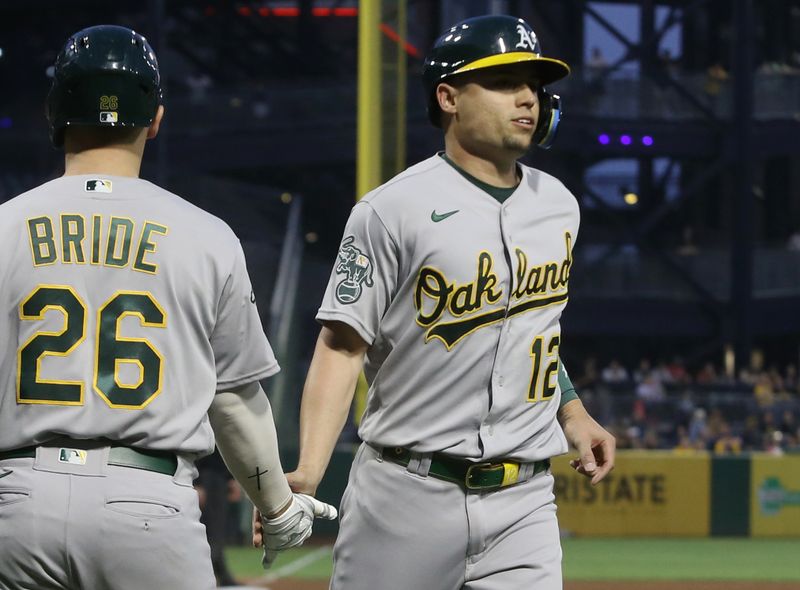 Jun 6, 2023; Pittsburgh, Pennsylvania, USA; Oakland Athletics third baseman Jonah Bride (26) congratulates shortstop Aledmys Diaz (12) after Diaz scored a run against the Pittsburgh Pirates during the sixth inning at PNC Park. Mandatory Credit: Charles LeClaire-USA TODAY Sports