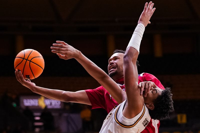 Jan 31, 2023; Laramie, Wyoming, USA; Fresno State Bulldogs guard Jemarl Baker (1) is fouled by Wyoming Cowboys forward Caden Powell (44) during the second half at Arena-Auditorium. Mandatory Credit: Troy Babbitt-USA TODAY Sports