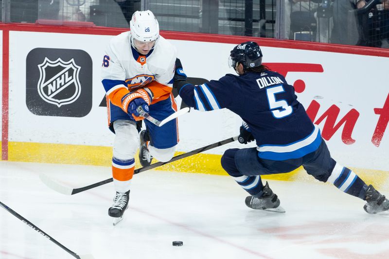 Jan 16, 2024; Winnipeg, Manitoba, CAN; New York Islanders forward Oliver Wahlstrom (26) tries to skate past Winnipeg Jets defenseman Brenden Dillon (5) during the third period at Canada Life Centre. Mandatory Credit: Terrence Lee-USA TODAY Sports