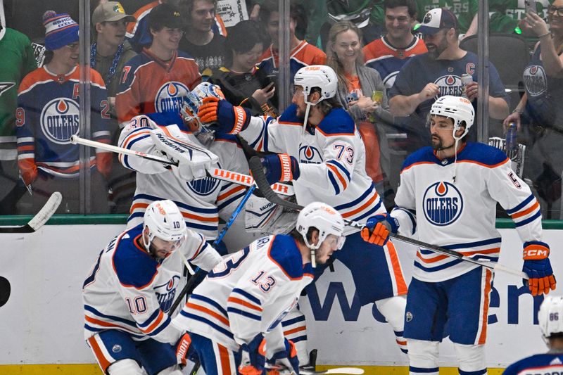 May 25, 2024; Dallas, Texas, USA; Edmonton Oilers defenseman Vincent Desharnais (73) playfully checks goaltender Calvin Pickard (30) against the glass as they warm up before the game between the Dallas Stars and the Edmonton Oilers in game two of the Western Conference Final of the 2024 Stanley Cup Playoffs at American Airlines Center. Mandatory Credit: Jerome Miron-USA TODAY Sports