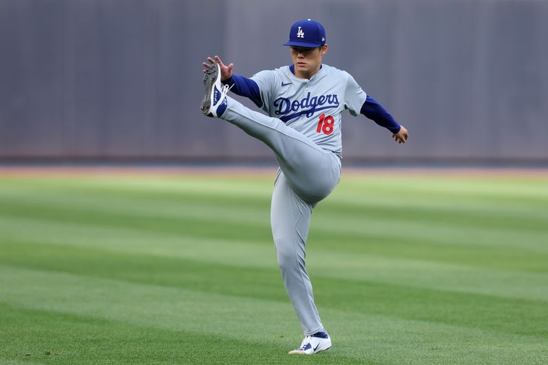 Jun 7, 2024; Bronx, New York, USA; Los Angeles Dodgers starting pitcher Yoshinobu Yamamoto (18) warms up before his start against the New York Yankees at Yankee Stadium. Mandatory Credit: Brad Penner-USA TODAY Sports